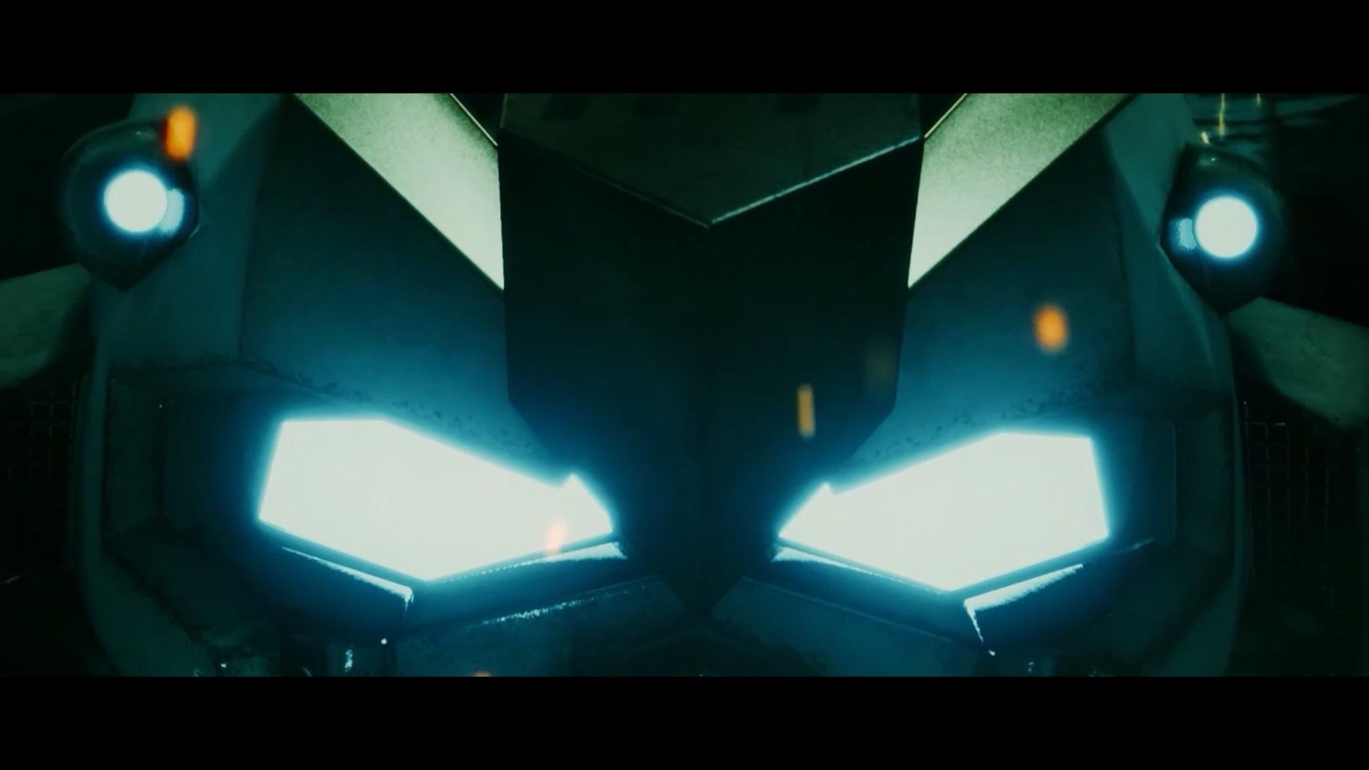 Close-up of Gundam head with bright cyan glowing eyes and sparks in the air